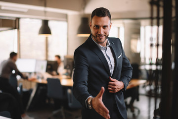 Fototapeta premium Businessman gives a hand for handshaking 