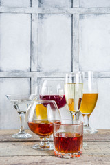 Selection of different alcoholic drinks - beer, red white wine, martini, champagne, cognac, whiskey in various glasses