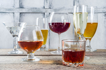 Selection of different alcoholic drinks - beer, red white wine, martini, champagne, cognac, whiskey...