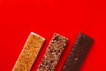 Fitness bars top view. Chocolate bars close-up. Open fitness bars with different fillings and tastes. Sports nutrition.