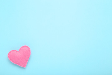 Pink fabric heart on blue background
