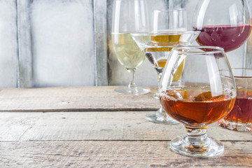 Selection of different alcoholic drinks - beer, red white wine, martini, champagne, cognac, whiskey in various glasses