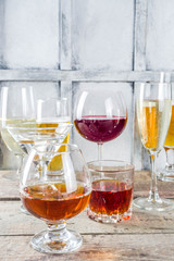 Selection of different alcoholic drinks - beer, red white wine, martini, champagne, cognac, whiskey in various glasses