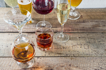 Selection of different alcoholic drinks - beer, red white wine, martini, champagne, cognac, whiskey in various glasses