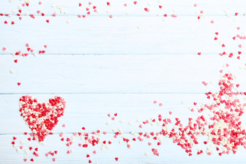 Obraz premium Heart shaped sprinkles on wooden table