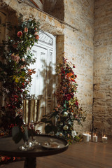Fototapeta na wymiar decor of the wedding ceremony. classic candles flowers wedding arch