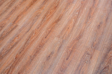 The floor of the light brown laminate diagonally
