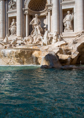 Lots of coins in the Trevi Fountain in Rome as seen from the front