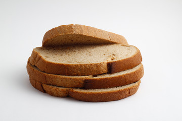 Isolate of white loaf of bread with sliced ​​pieces on a white background