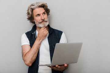 Portrait of a handsome stylish mature man wearing a vest