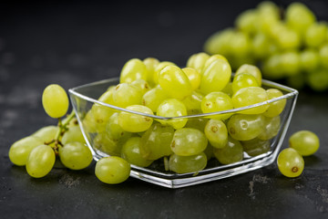 Fresh made White Grapes on a slate slab (close-up shot; selective focus)