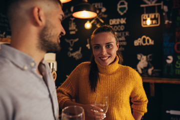 couple talking in bar , drinking beer