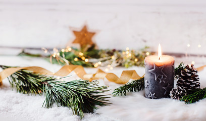 Romantic winter and christmas greeting card  - Burning candle with natural fir and pine cone decoration in scandinavian style, bright background and copy space 