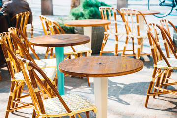 Street view of a coffee terrace with tables and chairs in europe