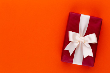 Christmas gift boxes with ribbons on color tabletop.