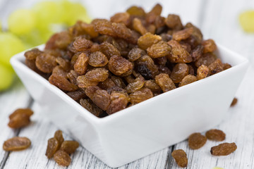 Portion of healthy Raisins (selective focus; close-up shot)