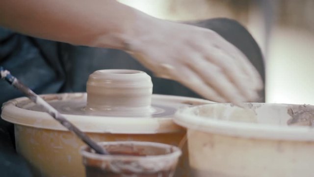 Close-up, Hands of The Potter Woman Make A Pot from Clay on the Pottery Circle