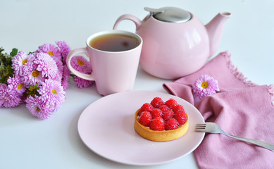 pink teapot, cup of tea and delicious raspberry cake