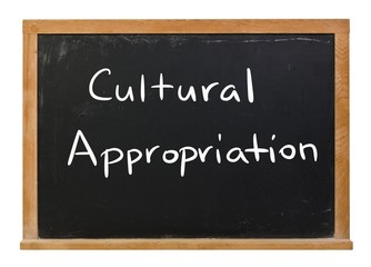 Cultural Appropriation written in white chalk on a black chalkboard isolated on white