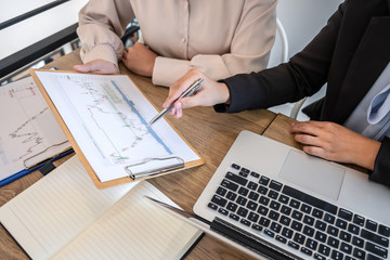 Businesswoman investor on meeting having planning and analyzing of partner cooperation in investment trading marketing project and pointing on the data presented and deal a stock exchange to profit
