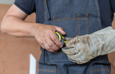 Selective focus of The carpenter man with measuring tape in hand , Craftsman concept.