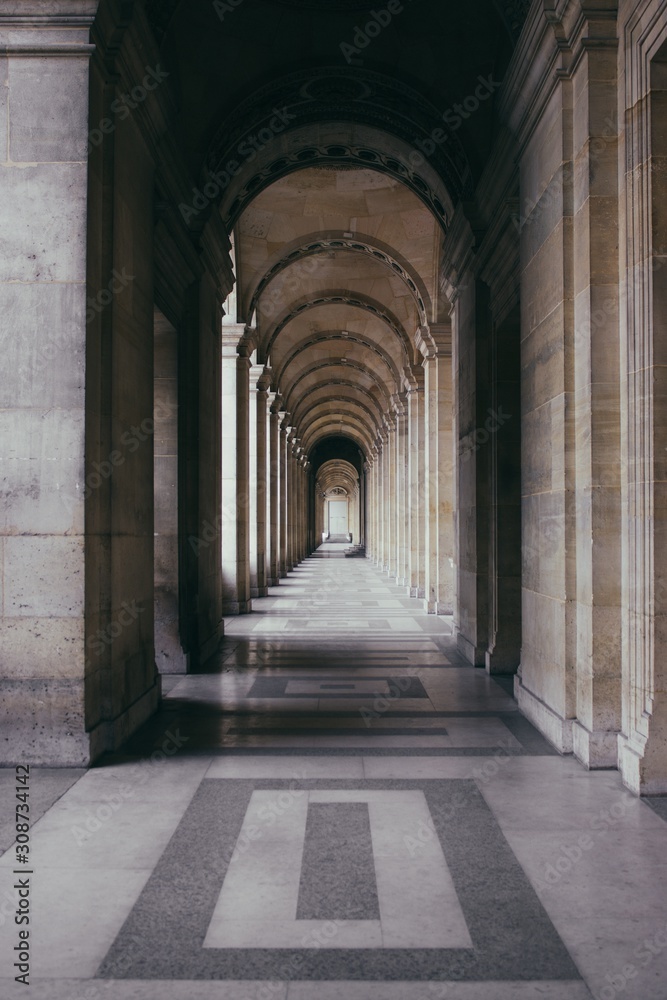 Poster vertical shot of an outdoor hallway of a historic building with outstanding architecture