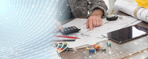 Architect working on plans; panoramic banner