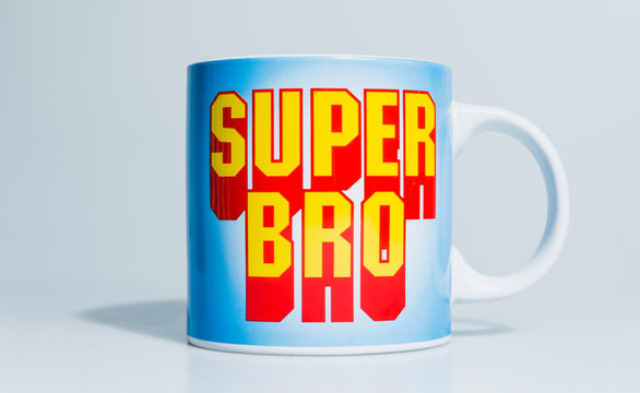 London, England, 24/10/2019 Super Bro mega mug on isolated white background lit professional in studio. Type in text font like mario or other retro games even superman comic book style
