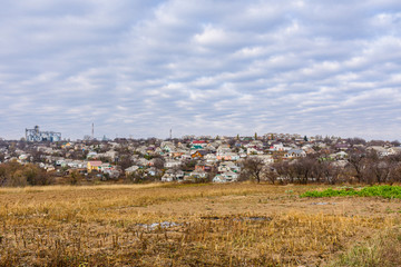 Fototapeta na wymiar Plowed field at autumn. City Uman on a background. Ukraine