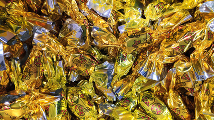 A heap of hungarian christmas sweetness fondant wrapped in various colorful metal  papers