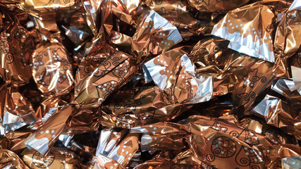A heap of hungarian christmas sweetness fondant wrapped in various colorful metal  papers