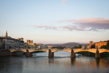 Fototapeta na wymiar View over a bridge on Arno river at sunset. Florence, Tuscany, Italy.