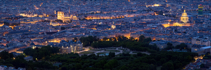 Fototapeta na wymiar Paris aerial panoramic view at twilight with Luxembourg Gardens, City Hall, illuminated Notre-Dame de Paris Cathedral and the Pantheon. Paris rooftops of the 4th, 5th and 6th Arrondissements. France