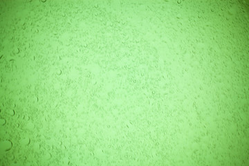Obraz premium Rain droplets on green glass background, Water drops on green glass.