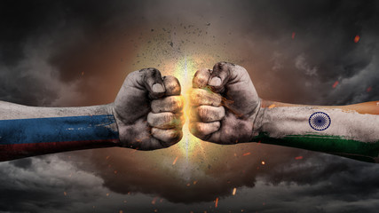 Russia vs India. Fists with flags. Battle of two countries on sky.	