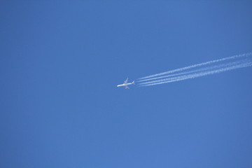 Inversion track of an airplane in the blue sky.