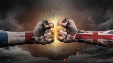 France vs UK. Fists with flags. Battle of two countries on sky.	