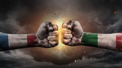 Italy vs France. Fists with flags. Battle of two countries on sky.	
