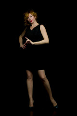 portrait of happy model pointing at something. On a black backgr