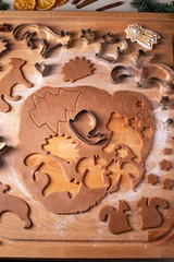 Cutting out pastry shapes for gingerbread Christmas cookies
