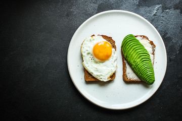avocado sandwich, healthy food (bread, toasts, ration diet, fried eggs) menu concept. food background. top view. copy space