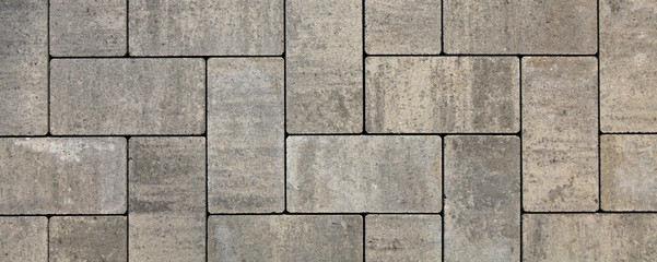 Regular shape blocks, texture, background. Paving slabs of gray blocks of flat shape, close-up. New...