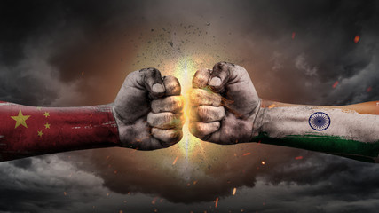 China vs India. Fists with flags. Battle of two countries on sky.	