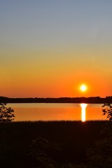 Obraz premium Orange sunrise on the lake