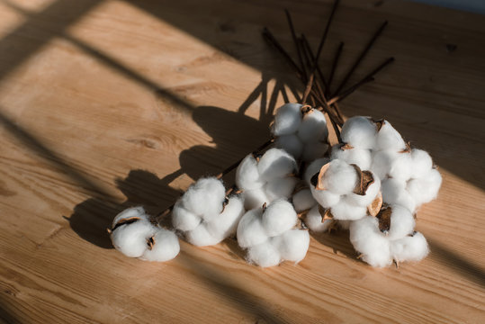 A bouquet of cotton on a wooden table.