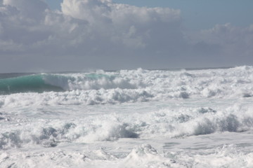 Naklejka na ściany i meble Foam of the sea. storm. white waves and blue background