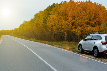 Suv car in autumn on the road.