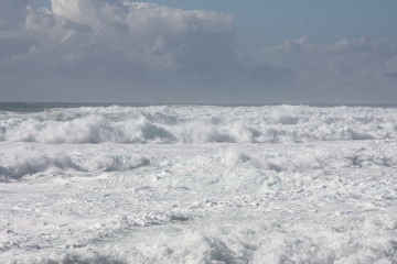 Fototapeta na wymiar Foam of the sea. storm. white waves and blue background