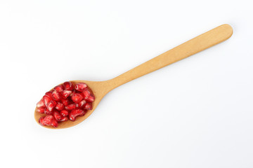 Red Pomegranate seed wooden spoon white background