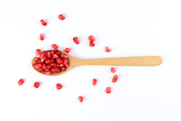 Red Pomegranate seed wooden spoon white background